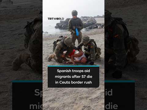 Spanish soldiers help exhausted migrants who swam to Ceuta after 57 died in border rush